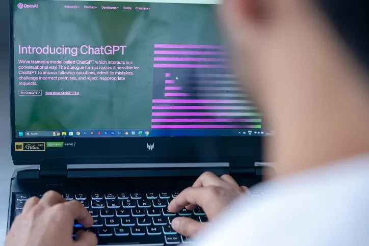 Man using ChatGPT on laptop