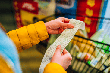 Woman checking receipt in grocery store