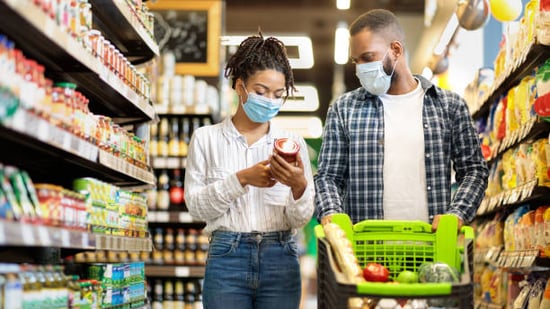 couple at a grocery store buying products