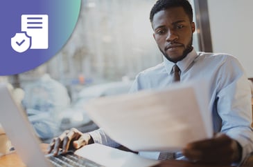 man working in an insurance company reviewing paperwork