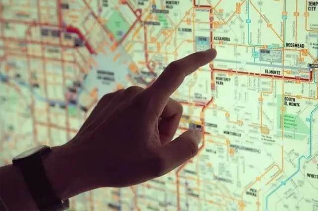 finger pointing at a map