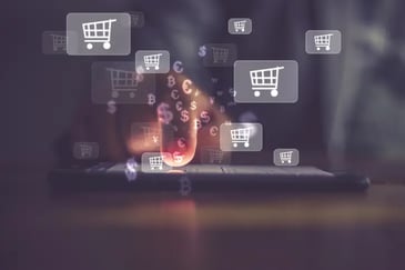 A finger on a tablet and images of dollar signs and shopping carts surrounding the image