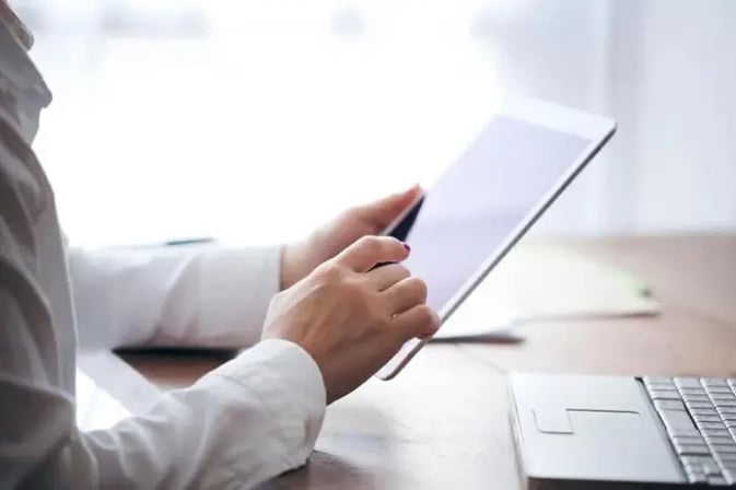 Female insurer using tablet in modern AI office