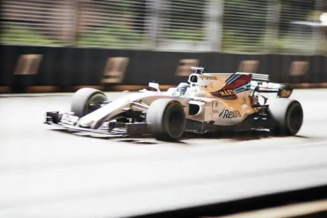 Formula 1 racecar driving on racetrack