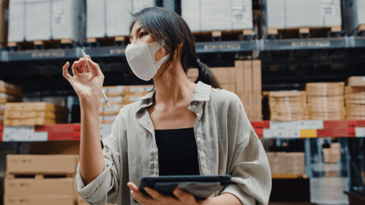 Female merchant doing stock inventory in warehouse