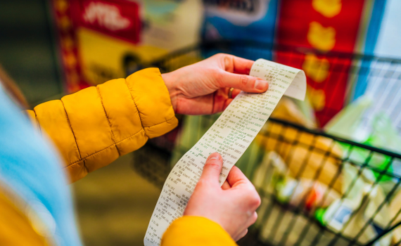 Shopper checking their grocery receipt