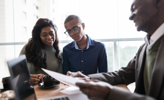 Male insurer meeting with male and female clients