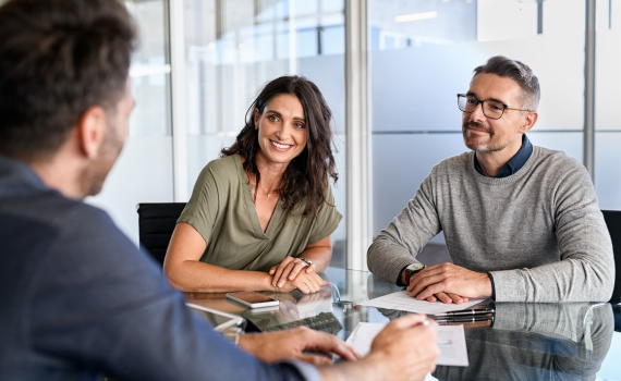 Male insurer talking to male and female clients