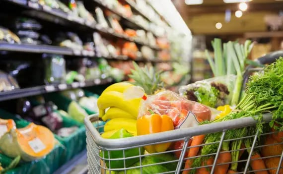 Close up on grocery cart filled with products