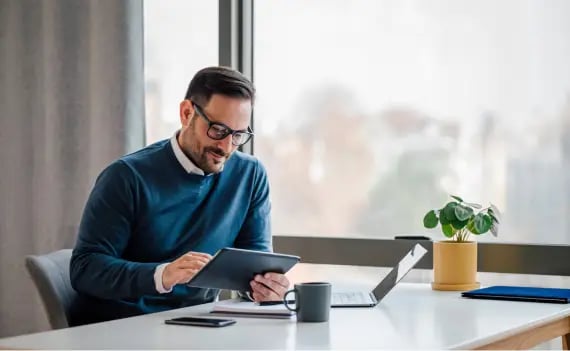 male executive using tablet at work desk