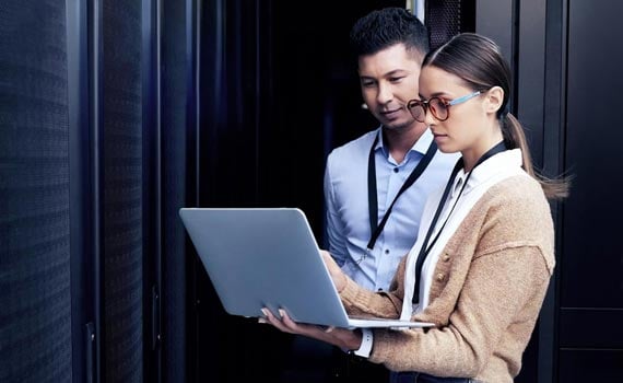 IT employees working on a laptop