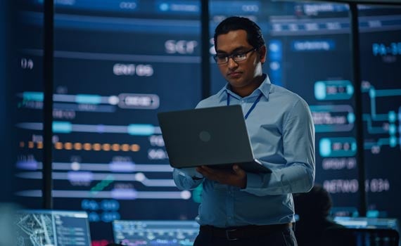 Man working on laptop in IT office