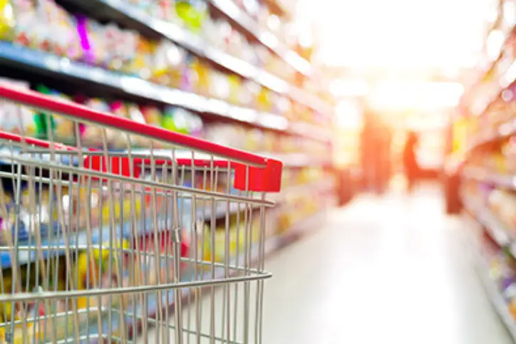 Shopping cart in grocery aisle