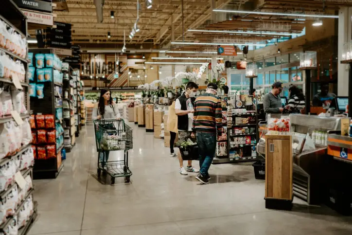 several people with masks grocery shopping