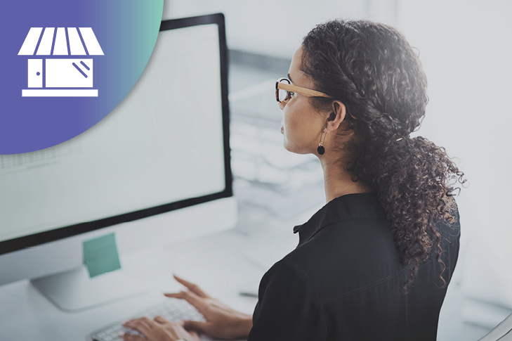 woman at her desk looking at her computer