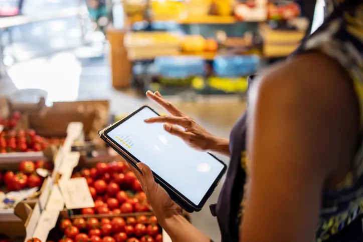 Lady using tablet in a grocery store