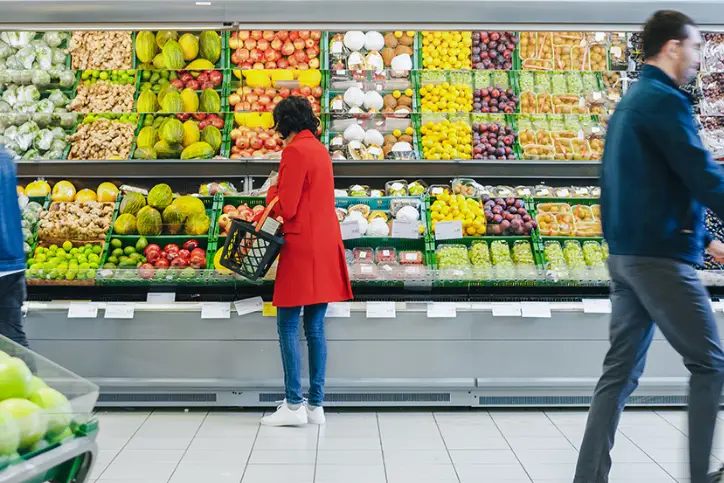 people shopping for fresh food in grocery store