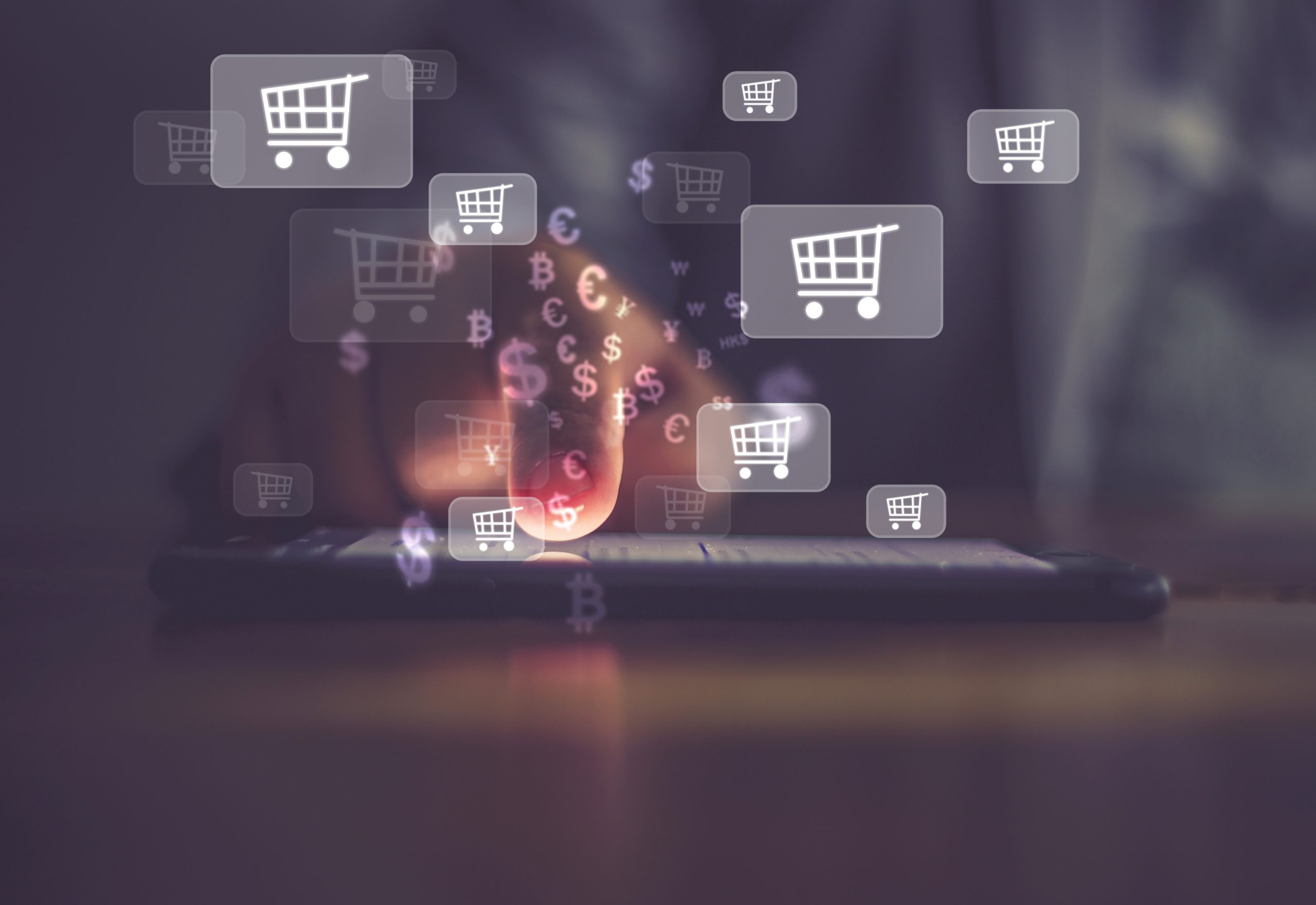 A finger on a tablet and images of dollar signs and shopping carts surrounding the image
