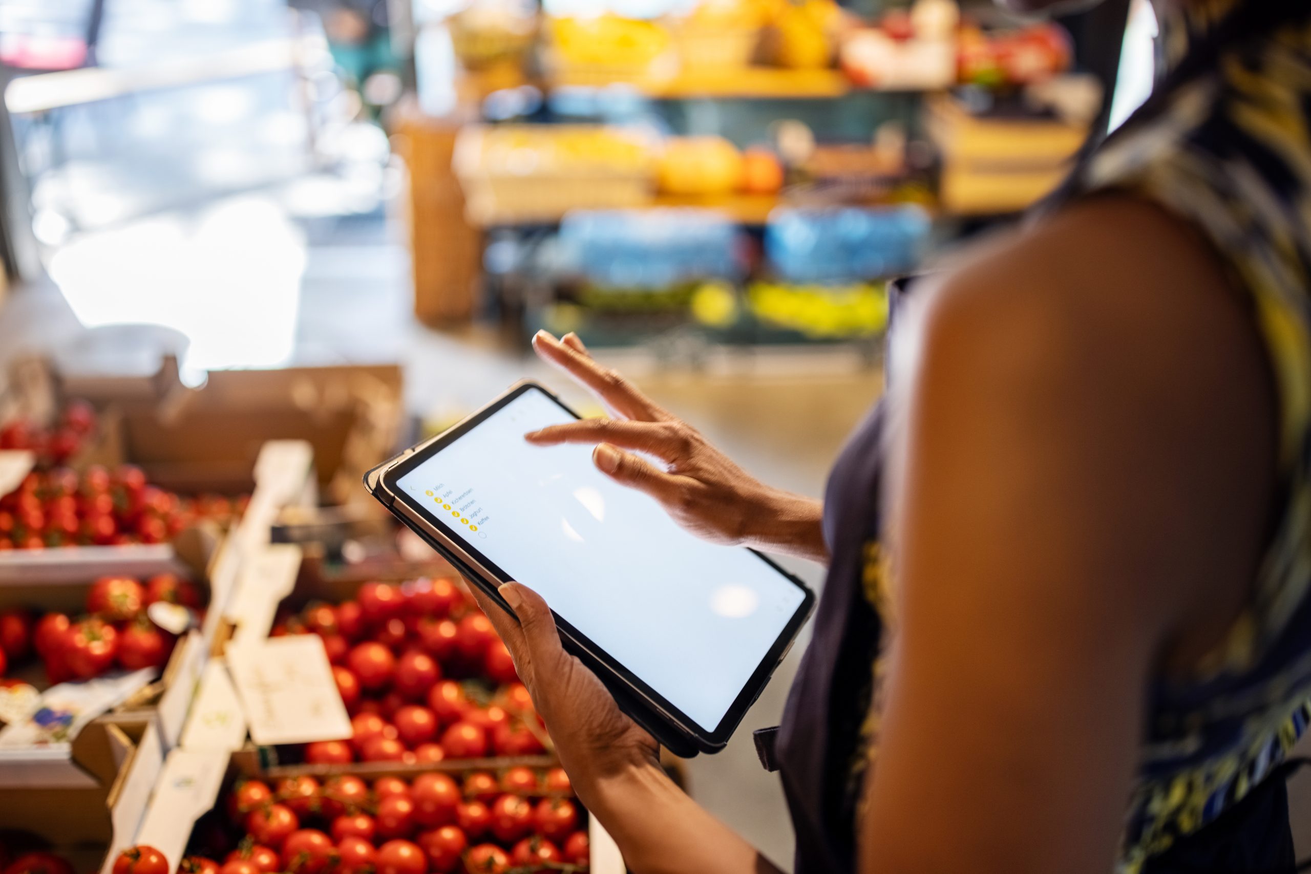Lady using tablet in a grocery store